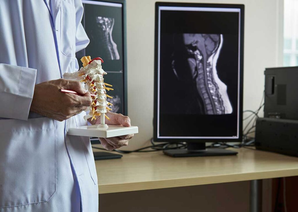 Person practicing slow breathing while seated with gentle support for lower back discomfort.